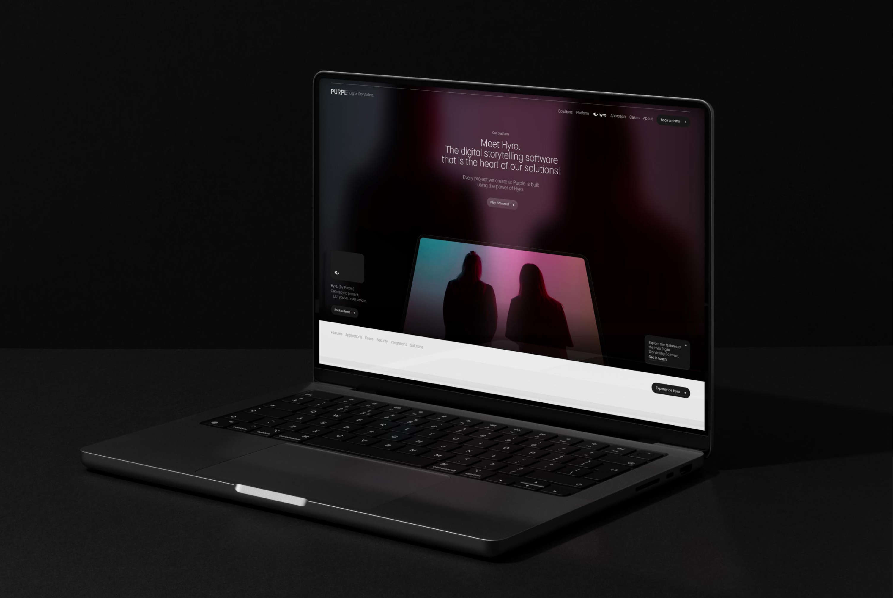 A laptop on a black background displaying the Hyro hero page