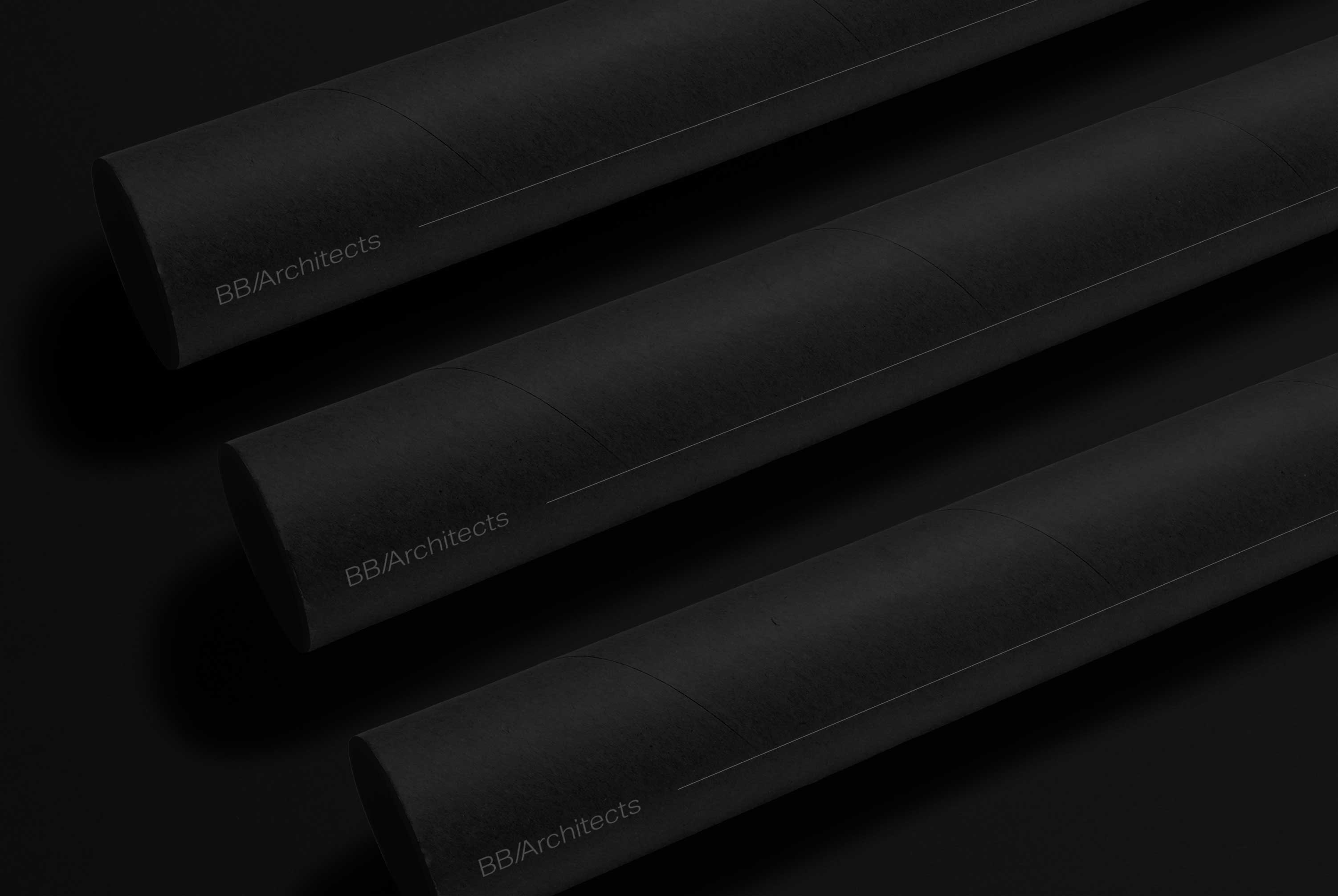 Three paper rolls on a black background with the BB/Architects logo printed on them.