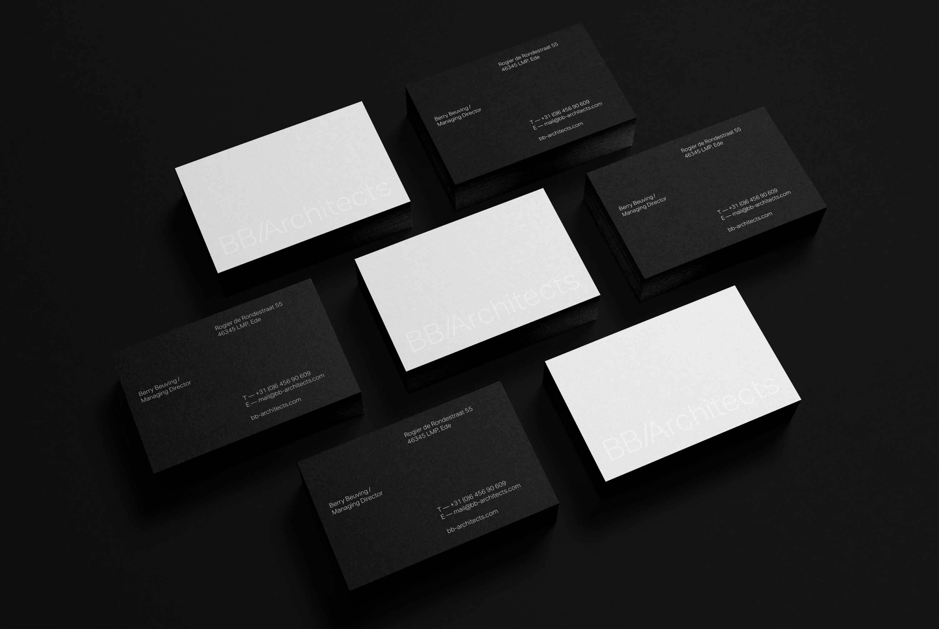 Various BB/Architects business cards on a black background.