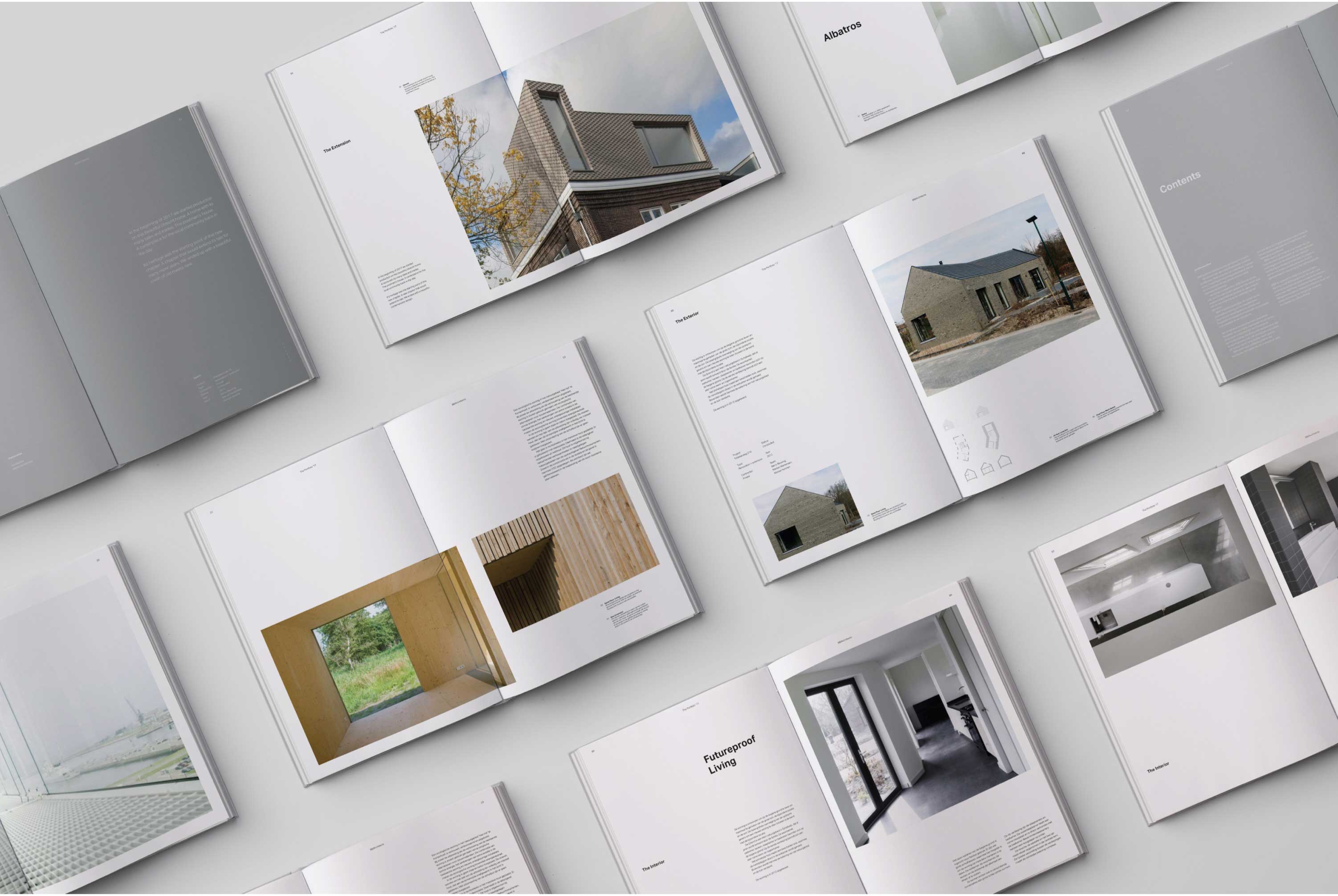 A collection of open books showing various projects of BB/Architects