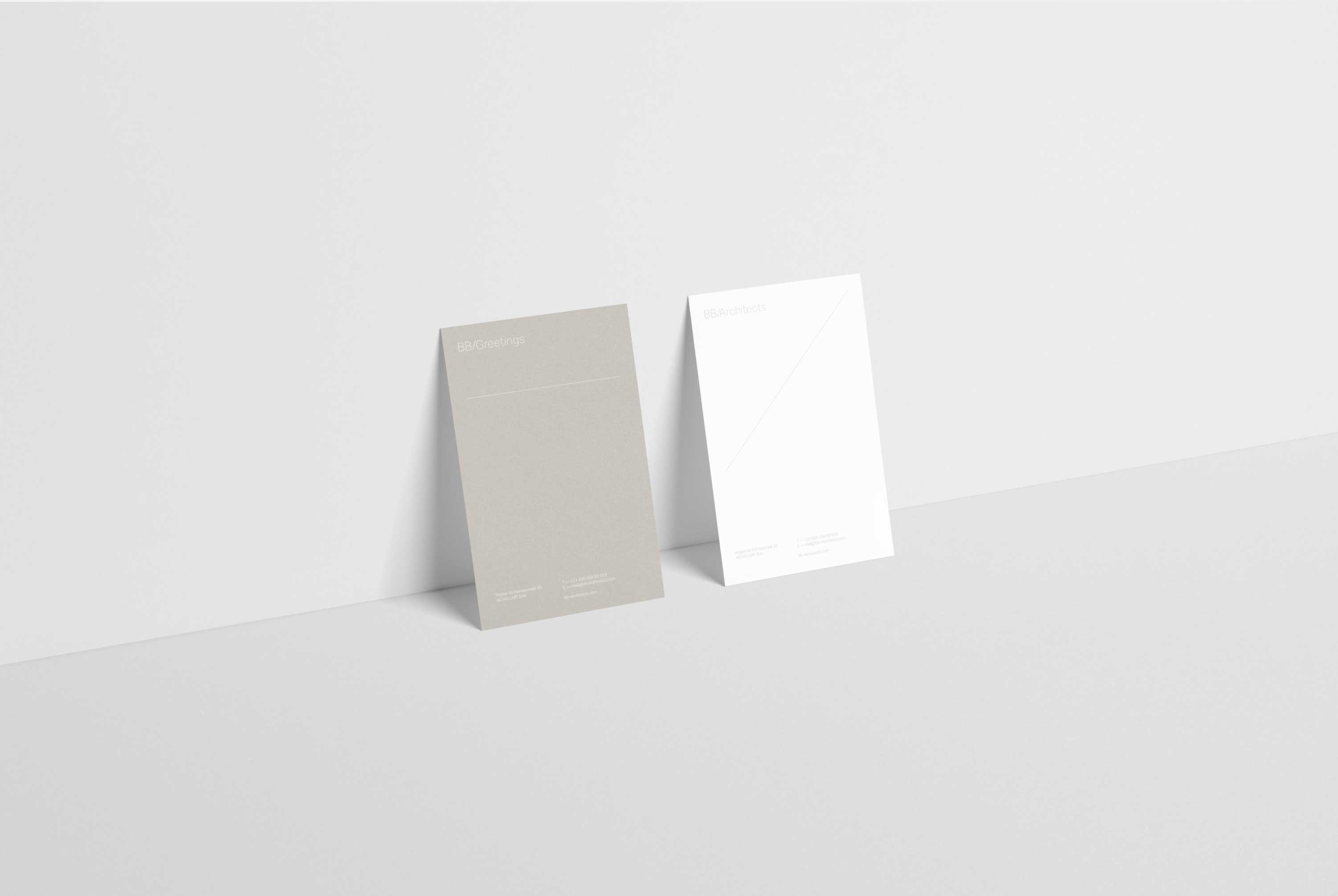 Two greeting cards standing up against a grey wall