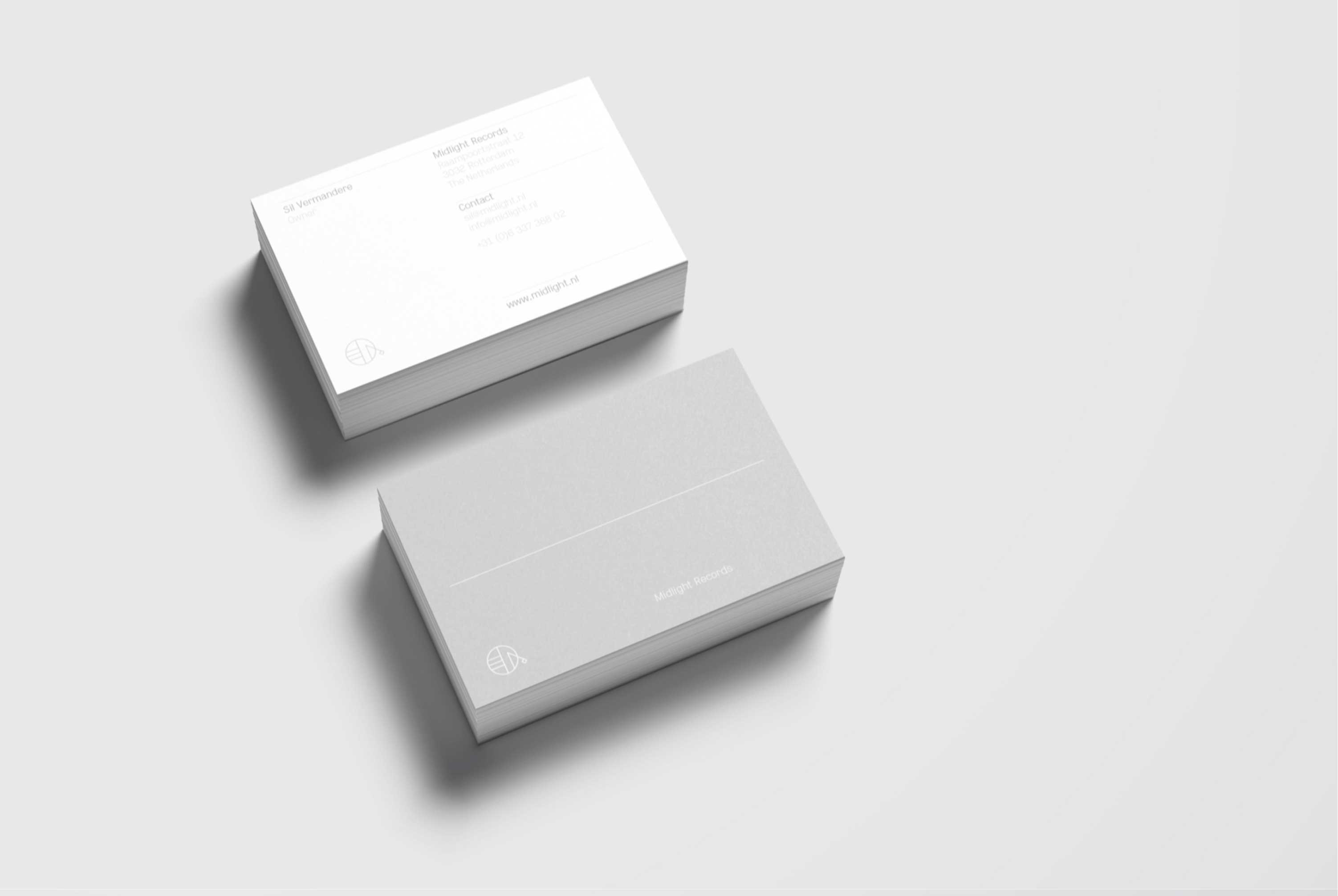 Midlight business cards on a grey background