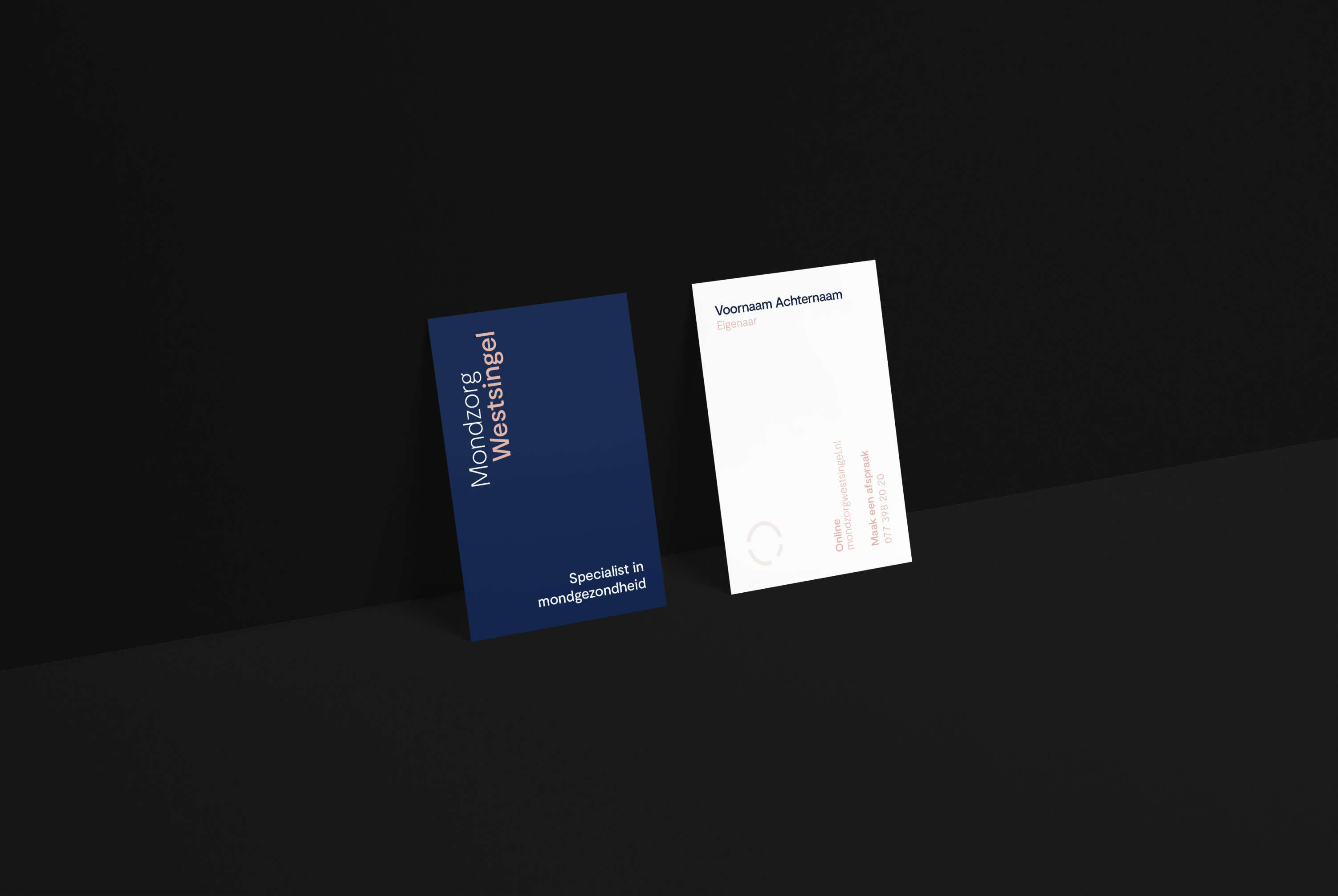 Two Mondzorg Westsingel business cards against a black wall