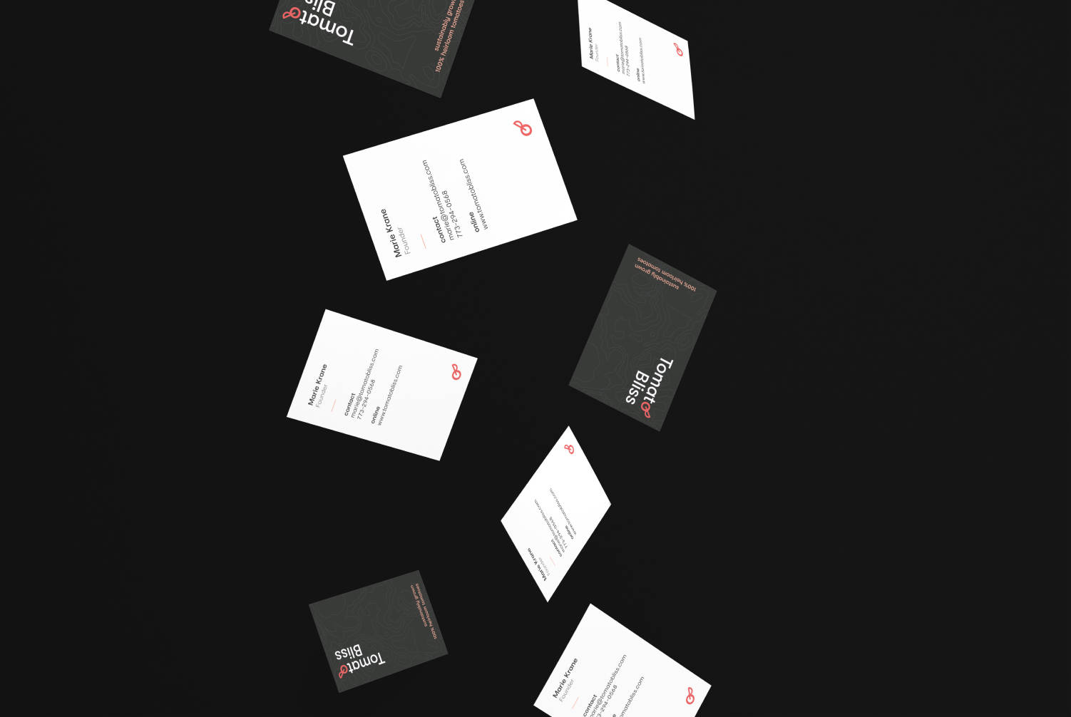 A few floating business cards with Tomato Bliss information on it