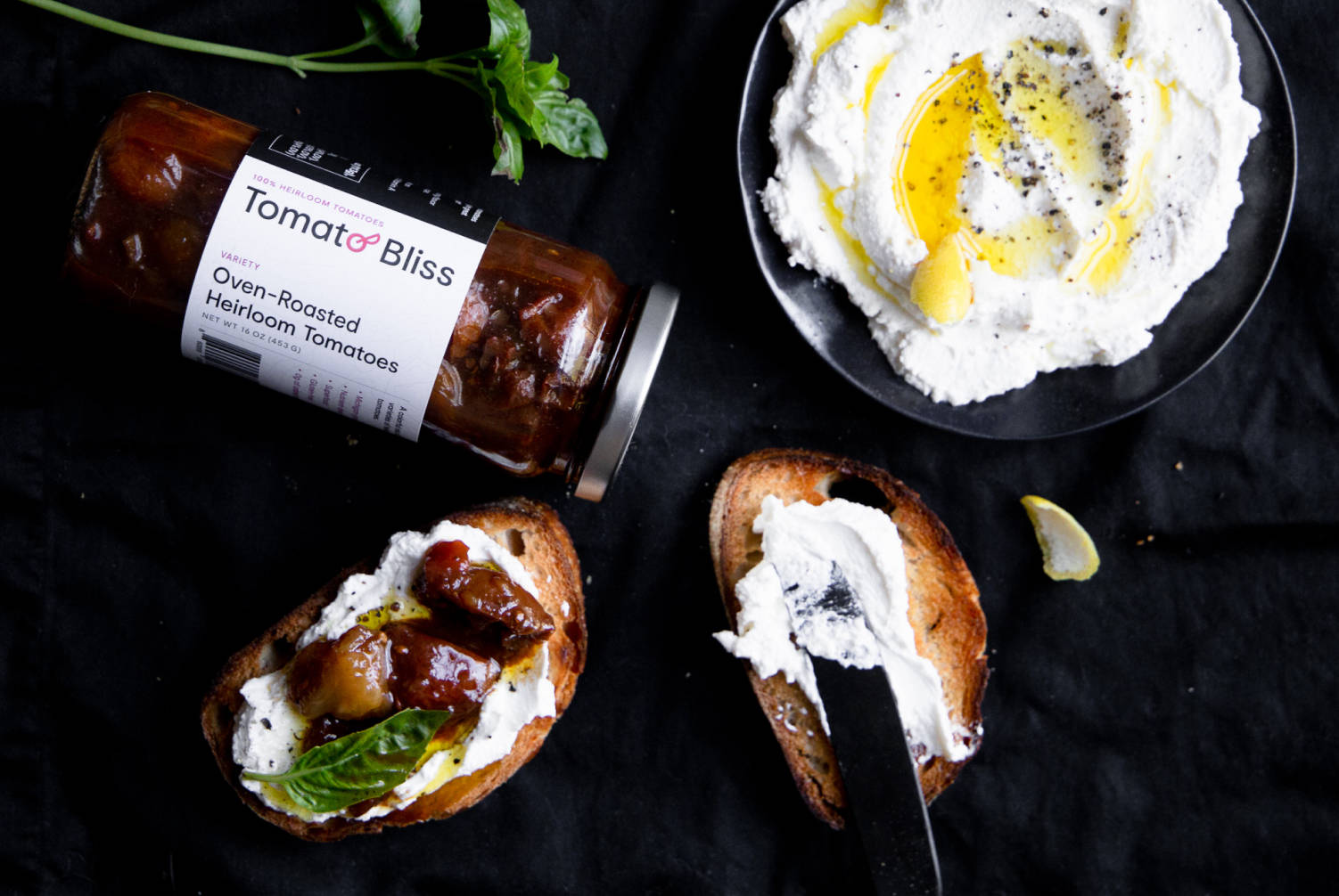 A jar of Tomato Bliss next to a tasty dish