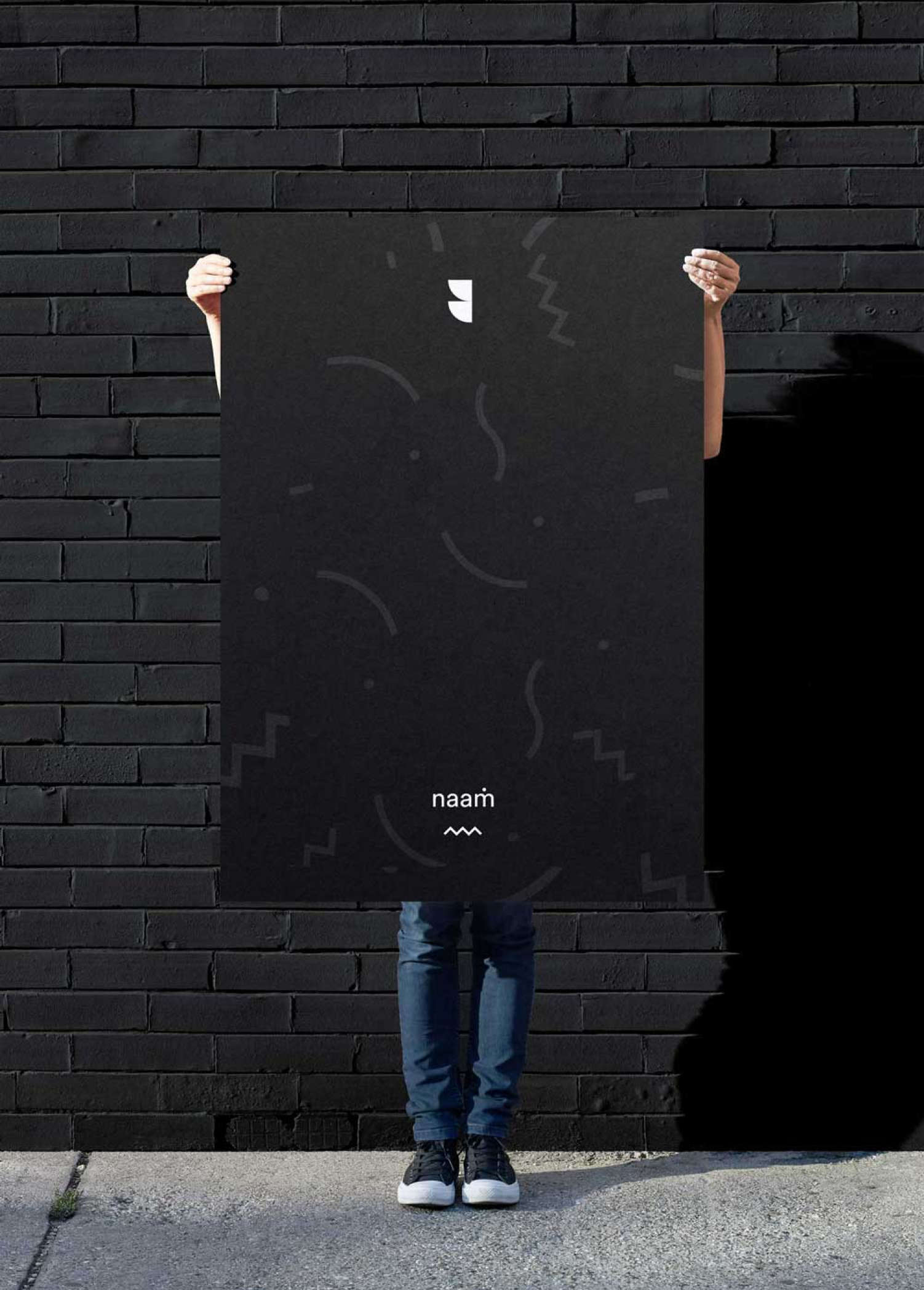 A person holding a poster with the new Naam Agency visual identity