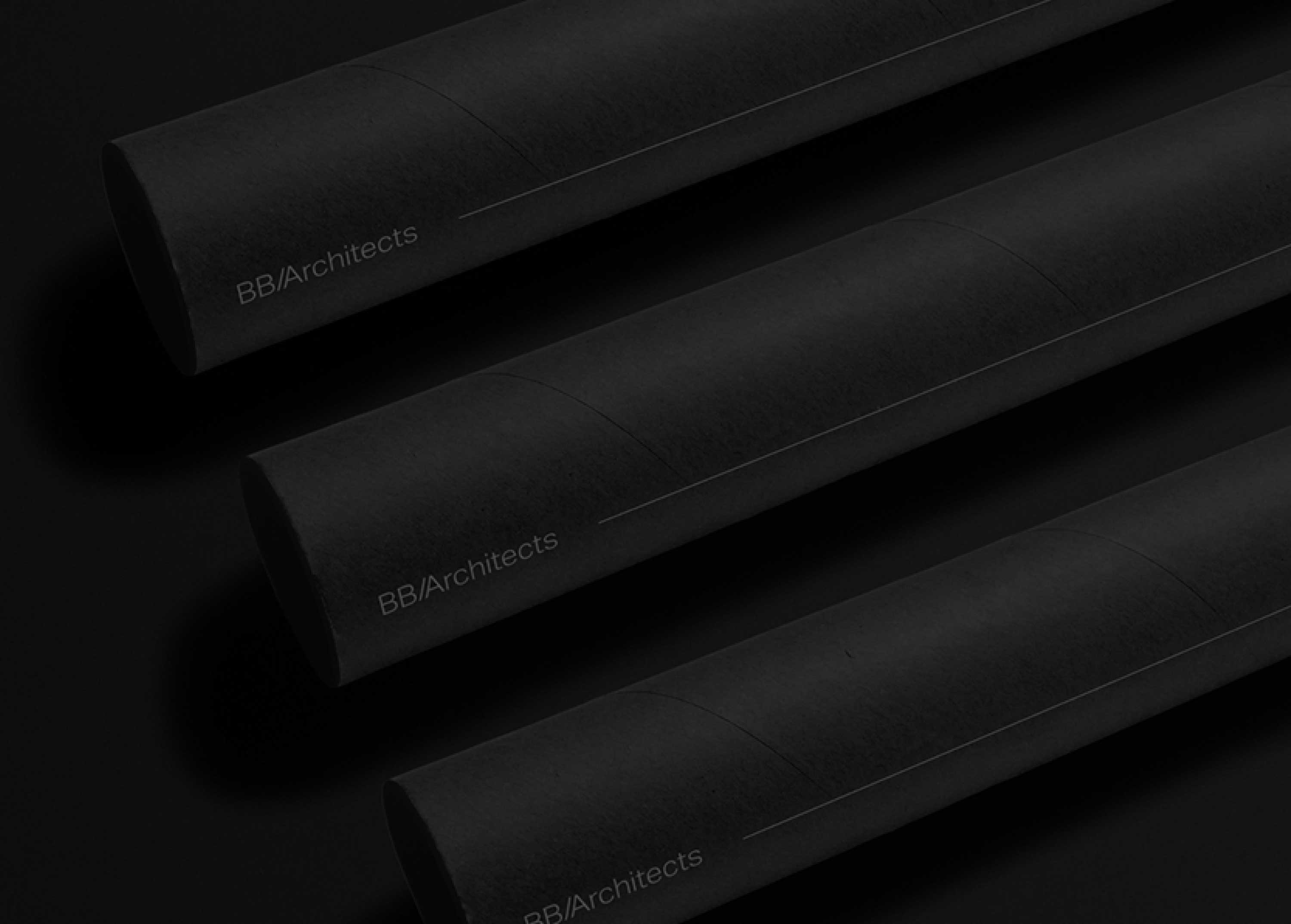 Three folded papers displaying the BB/Architects logo on a black background