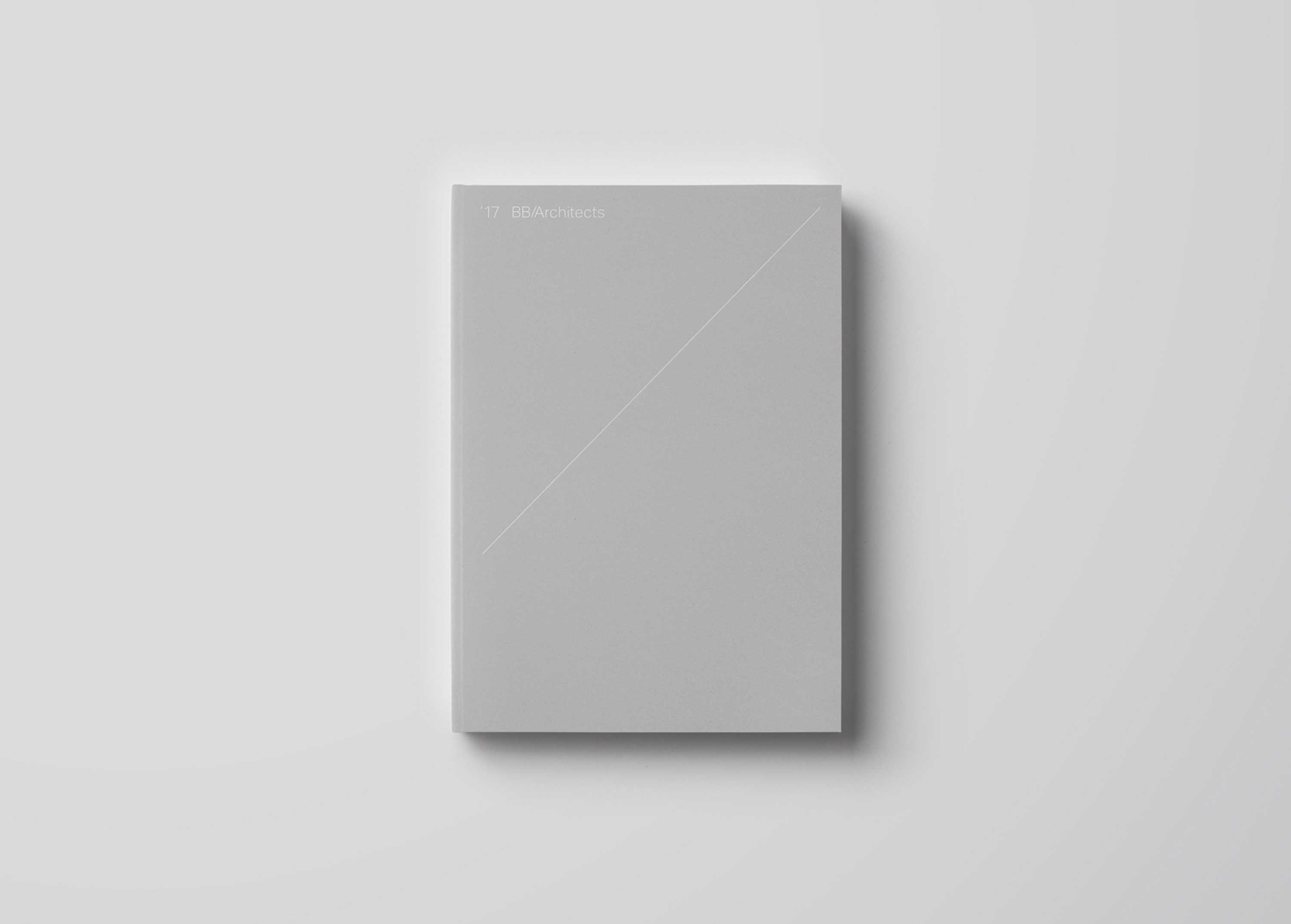 A grey BB/Architects portfolio book on a grey background