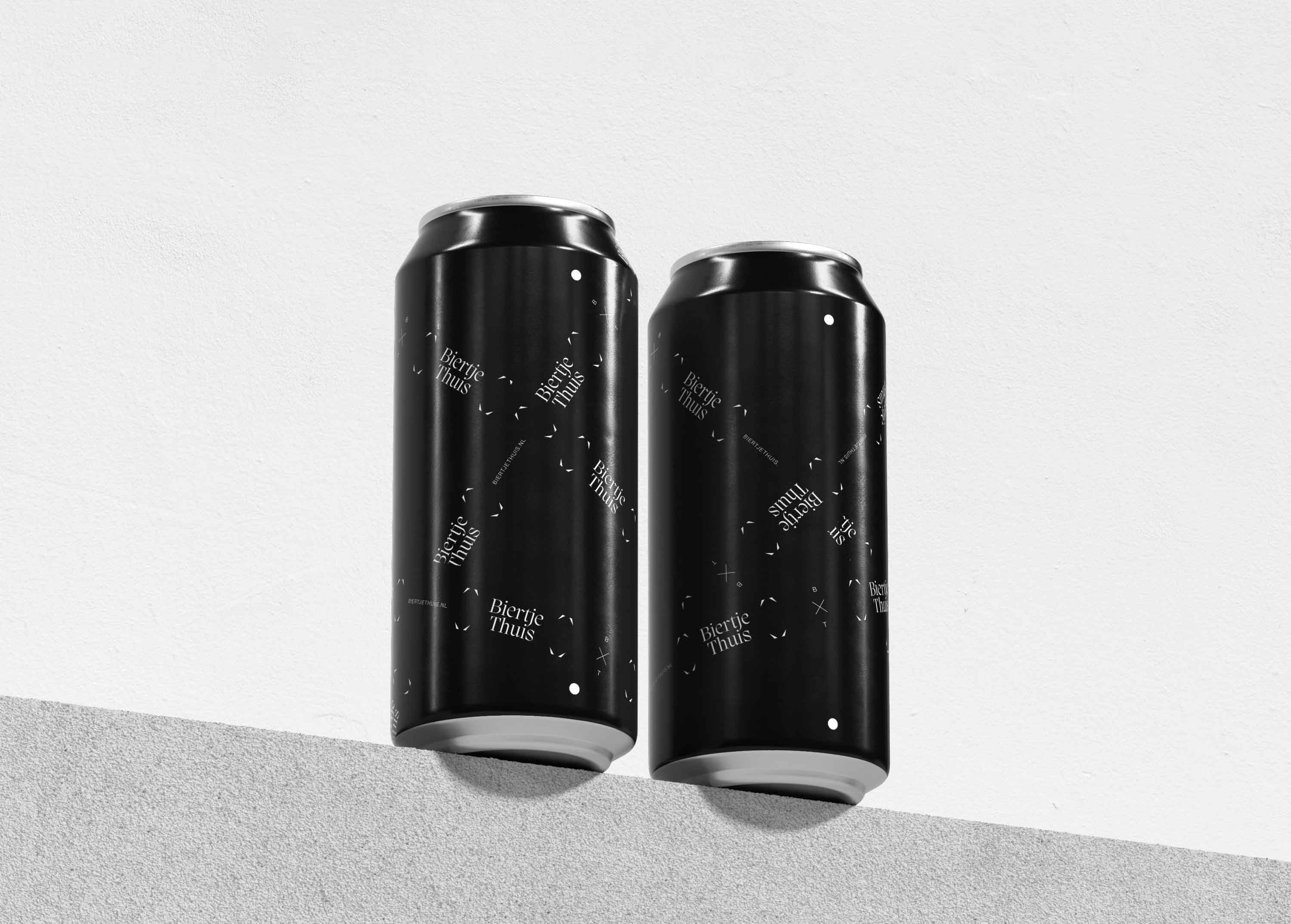 Two beer cans on a grey brick